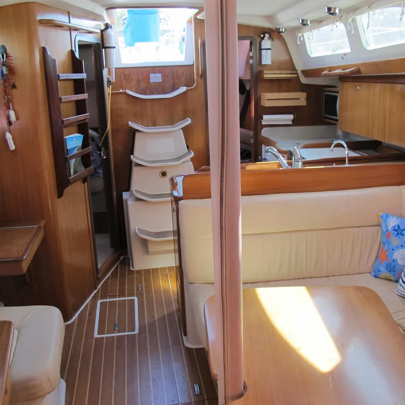 Slide: The Image of Interior of 2007 Catalina 387 sailboat with wood finish and cozy seating area. - 30