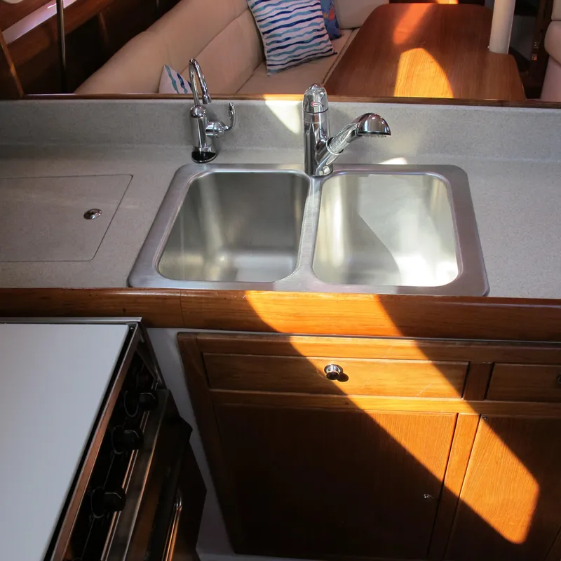 Slide: The Image of 2007 Catalina 387 yacht kitchen with double sink and wooden cabinetry. - 33