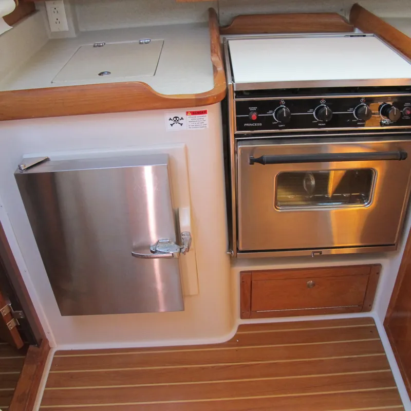 Slide: The Image of 2007 Catalina 387 yacht kitchen with stove, oven, and stainless steel fridge. - 35
