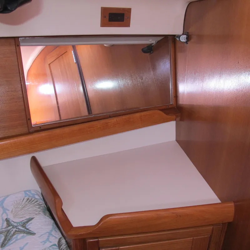 Slide: The Image of Interior of a 2007 Catalina 387 sailboat with wooden cabinetry and a mirror. - 39