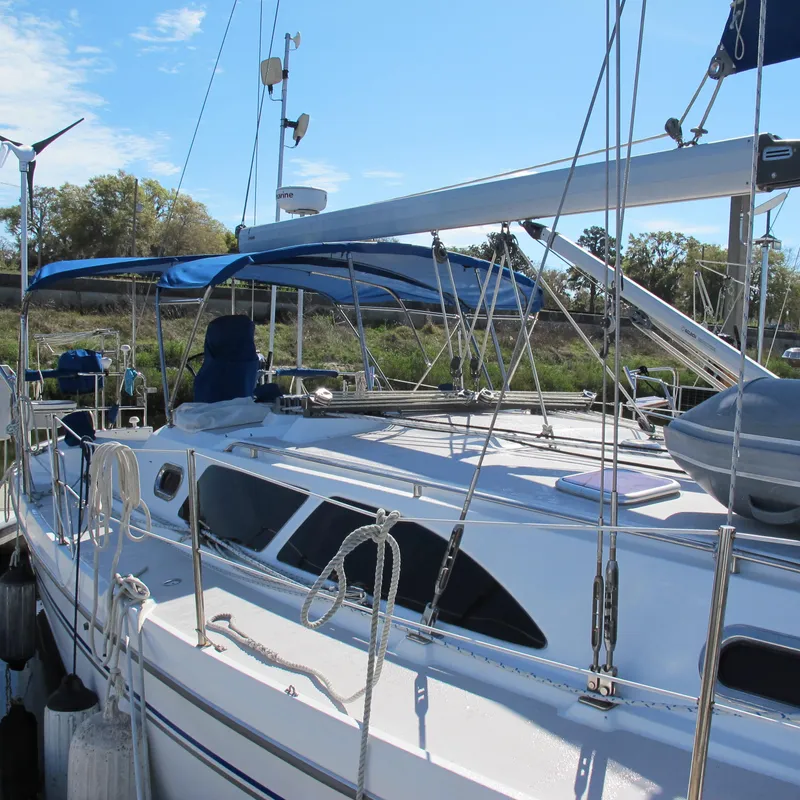 Slide: The Image of 2007 Catalina 387 sailboat docked with blue canopy and rigging. - 4
