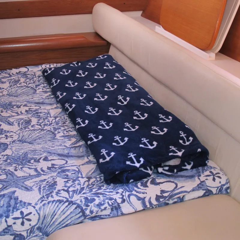 Slide: The Image of Nautical-themed bedding in a 2007 Catalina 387 cabin, featuring anchor and seashell patterns. - 41
