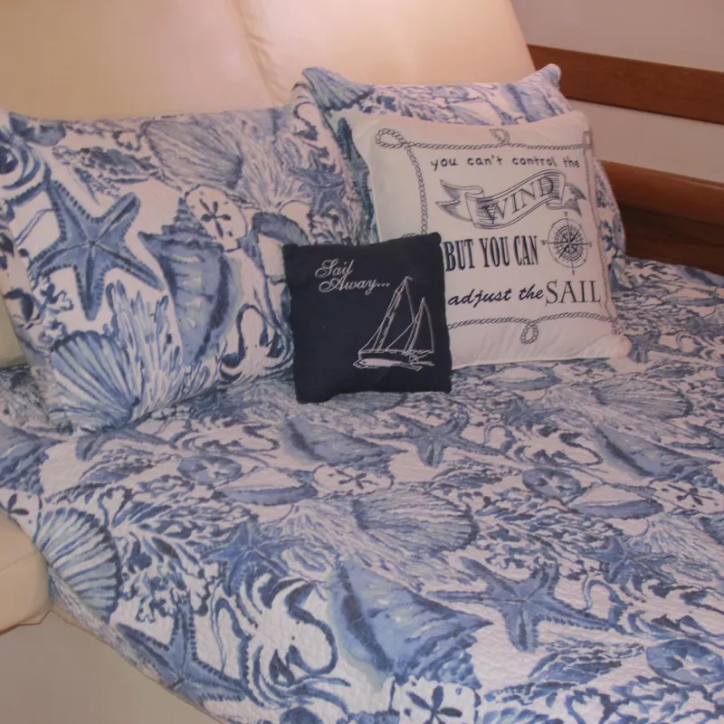 Slide: The Image of Nautical-themed bedding with decorative pillows on a Catalina 387, 2007 model. - 42