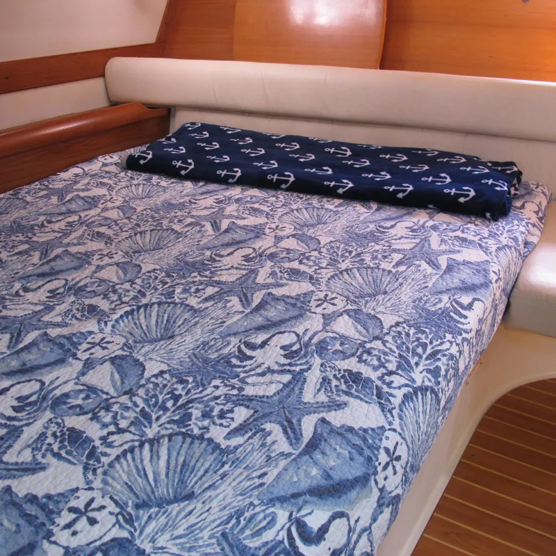 Slide: The Image of Cozy cabin bed in 2007 Catalina 387 yacht with nautical-themed bedding. - 44