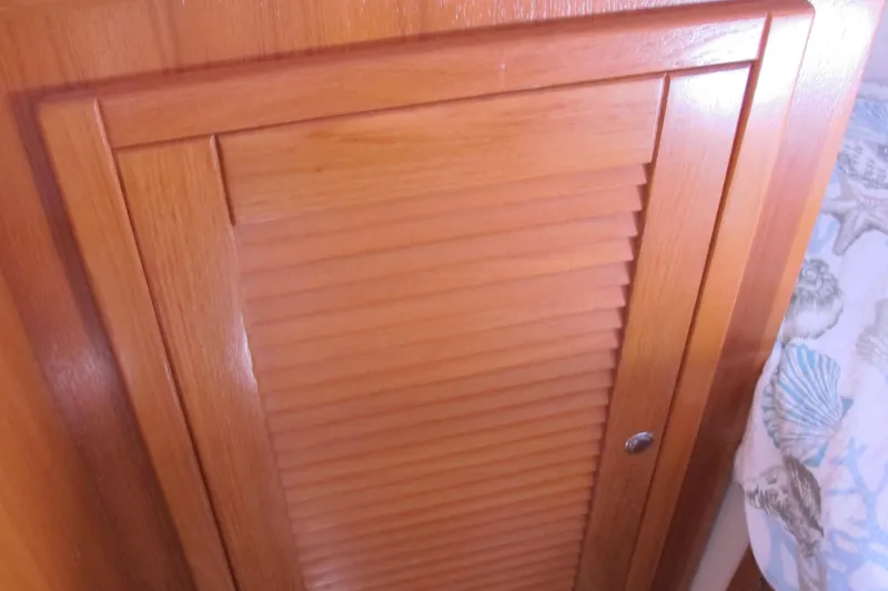 Slide: The Image of Wooden cabinet door inside a 2007 Catalina 387 sailboat interior. - 48