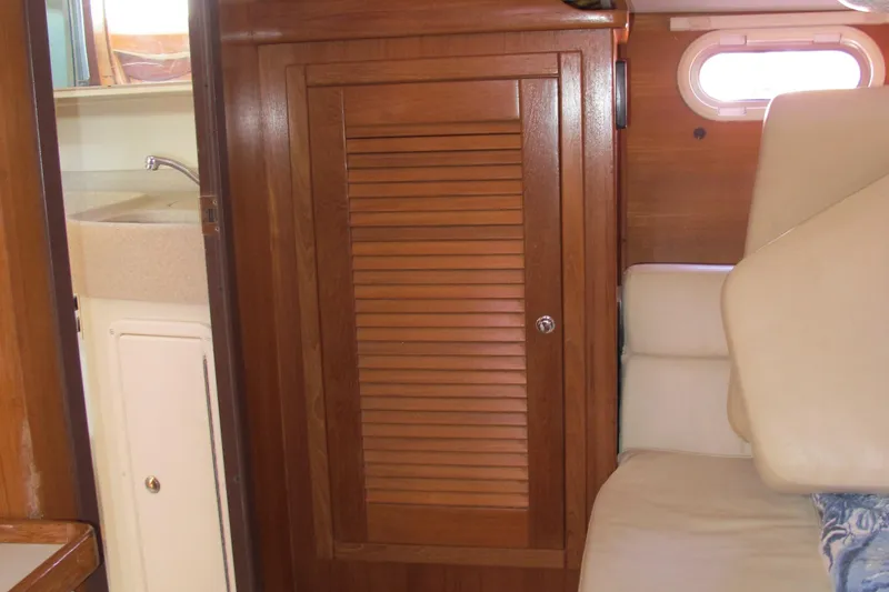 Slide: The Image of Interior of 2007 Catalina 387 sailboat with wooden cabinet and beige seating. - 49