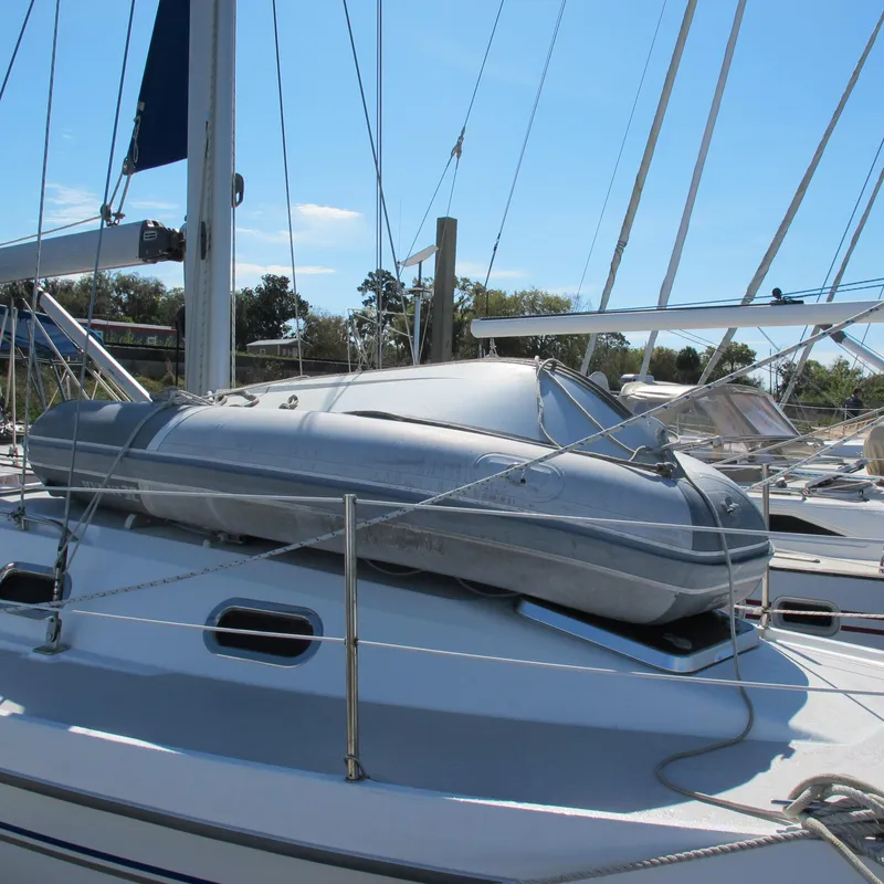 Slide: The Image of 2007 Catalina 387 sailboat with inflatable dinghy on deck, docked in marina. - 6