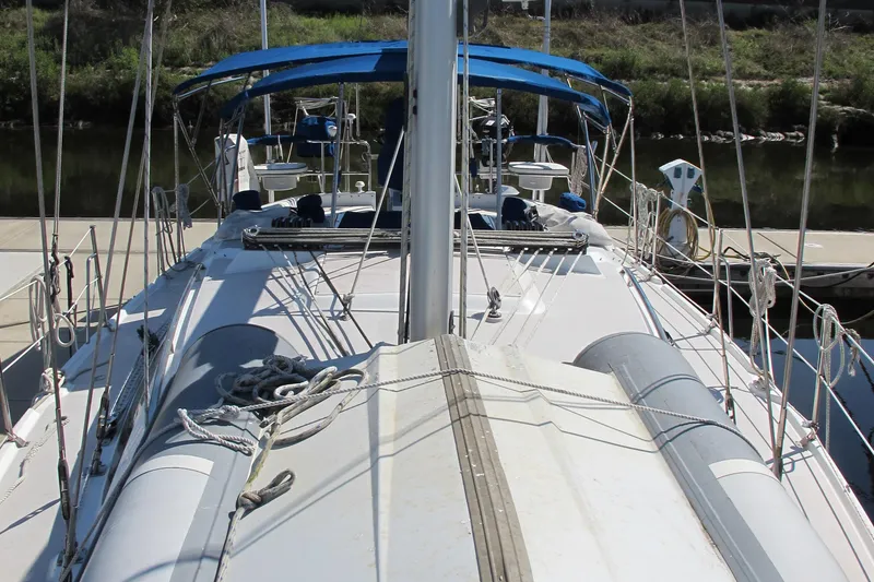 Slide: The Image of 2007 Catalina 387 sailboat with blue canopy docked at marina. - 7