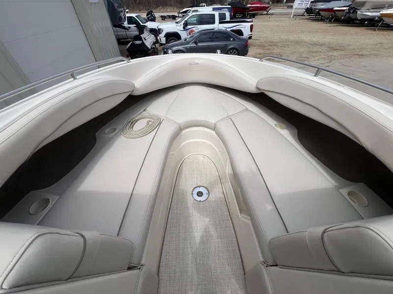 Slide: The Image of 2002 Maxum 2300 SR boat interior with beige seating and cup holders. - 11