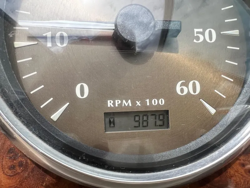 Slide: The Image of Close-up of a Maxum 2300 SR 2002 tachometer showing 987.9 RPM. - 19