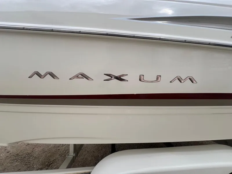 Slide: The Image of 2002 Maxum 2300 SR boat side view with logo detail. - 2