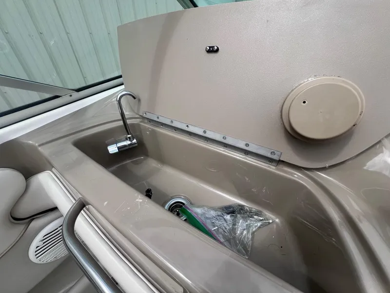 Slide: The Image of 2002 Maxum 2300 SR boat interior sink with faucet and storage compartment. - 24
