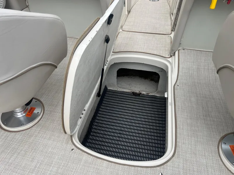 Slide: The Image of Open storage compartment on 2002 Maxum 2300 SR boat with gray interior. - 29