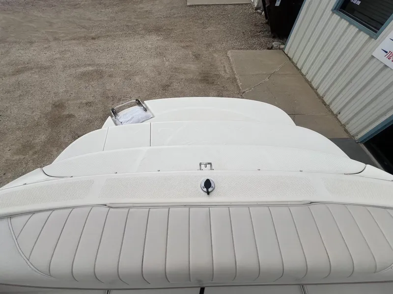 Slide: The Image of 2002 Maxum 2300 SR boat's rear deck with white upholstery and swim platform. - 30