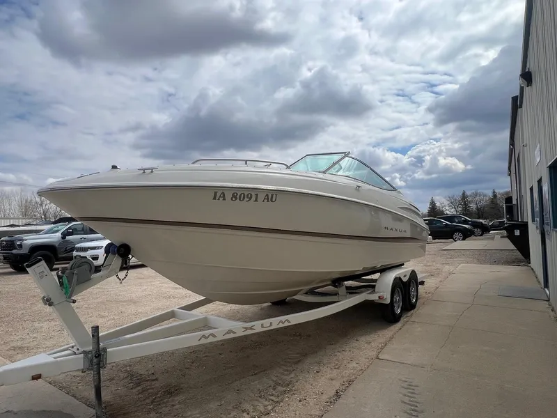 Slide: The Image of 2002 Maxum 2300 SR boat on trailer, parked outdoors under cloudy sky. - 4