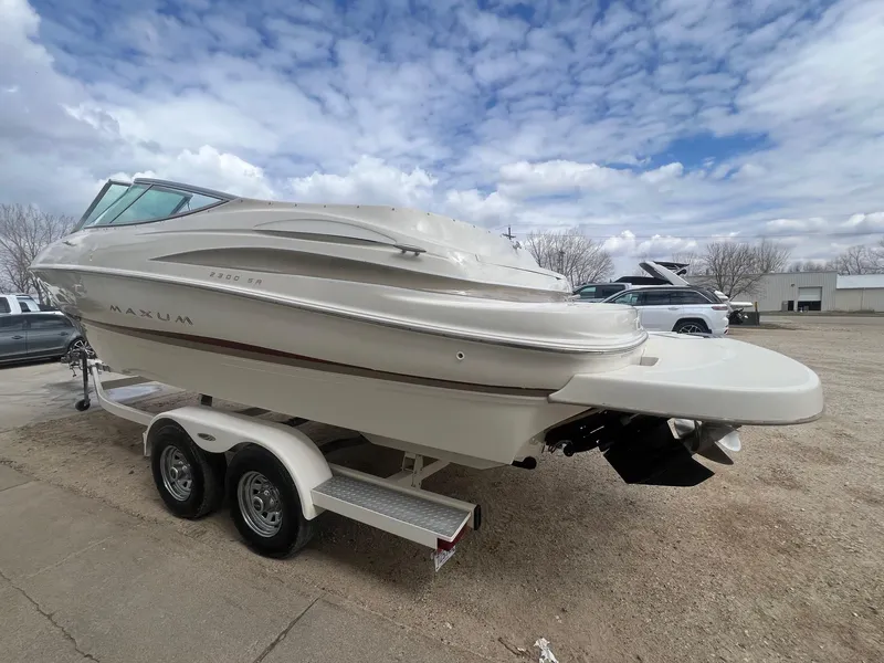 Slide: The Image of 2002 Maxum 2300 SR boat on trailer under cloudy sky. - 6