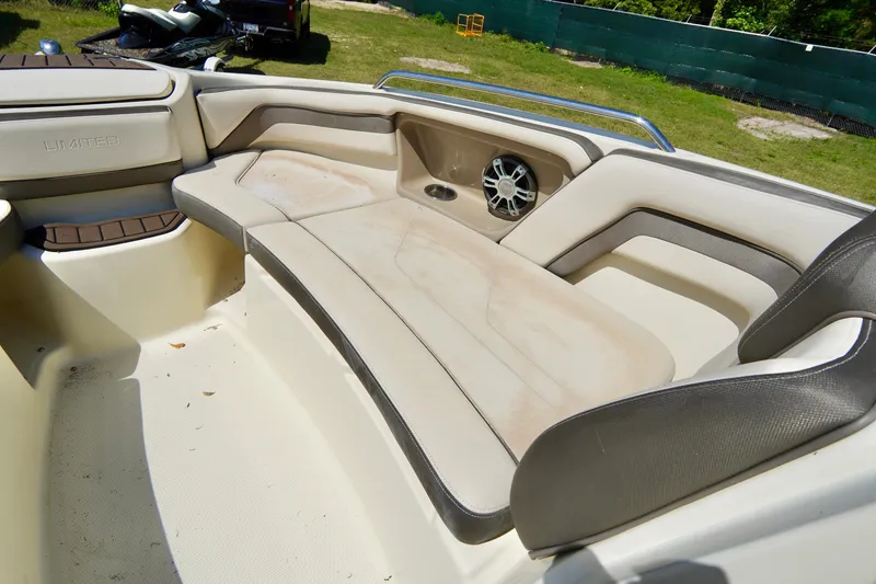 Slide: The Image of 2015 Yamaha Boats 242 Limited S interior seating with speaker, beige and brown upholstery. - 10