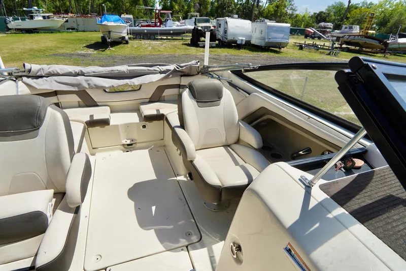 Slide: The Image of 2015 Yamaha Boats 242 Limited S interior with seating, parked outdoors. - 15