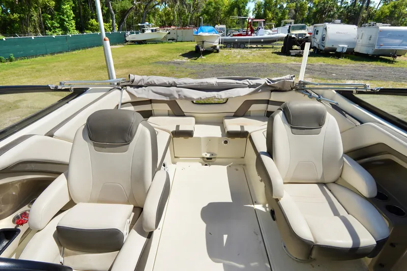 Slide: The Image of 2015 Yamaha Boats 242 Limited S interior with beige seating and open deck. - 16