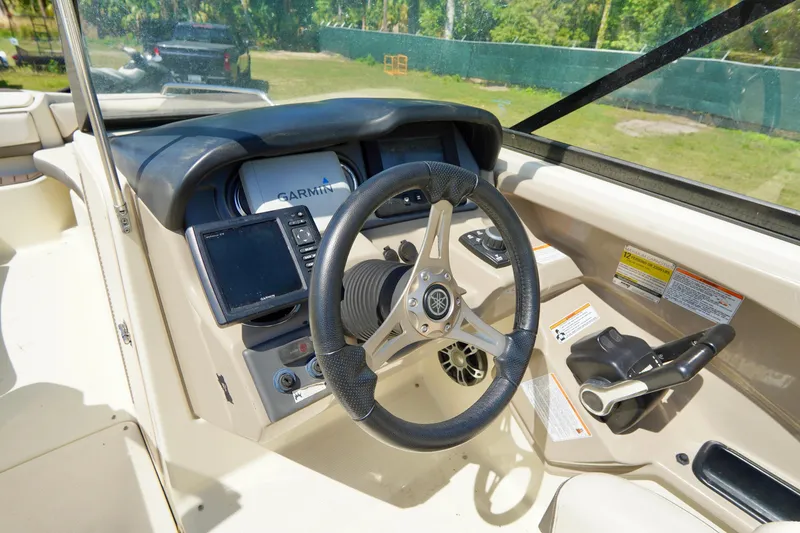 Slide: The Image of 2015 Yamaha Boats 242 Limited S dashboard with steering wheel and navigation controls. - 18
