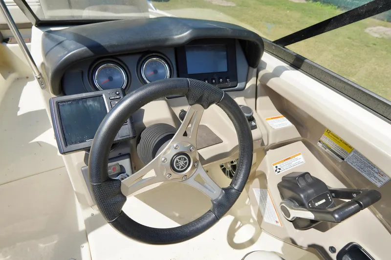 Slide: The Image of 2015 Yamaha Boats 242 Limited S dashboard with steering wheel and control panel. - 19