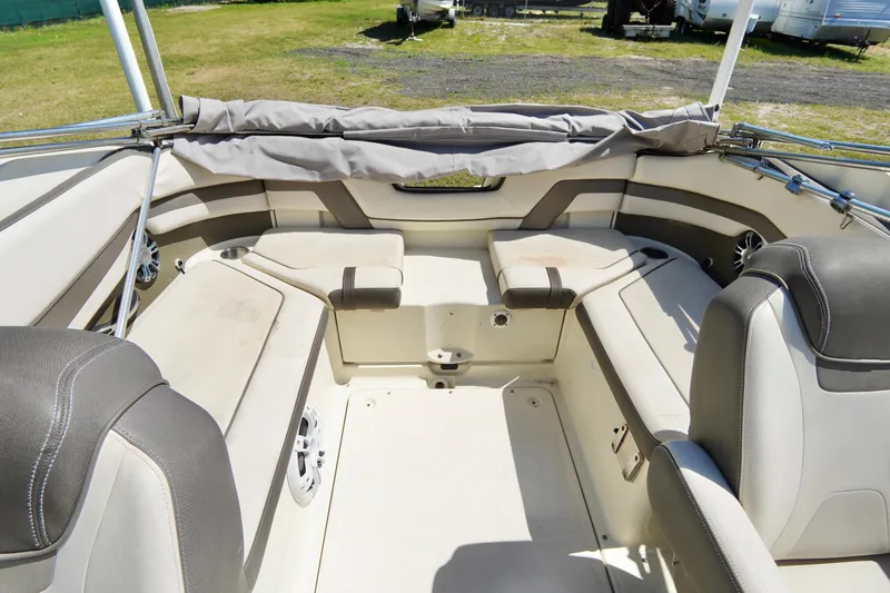 Slide: The Image of 2015 Yamaha Boats 242 Limited S interior with beige seating and open deck layout. - 29