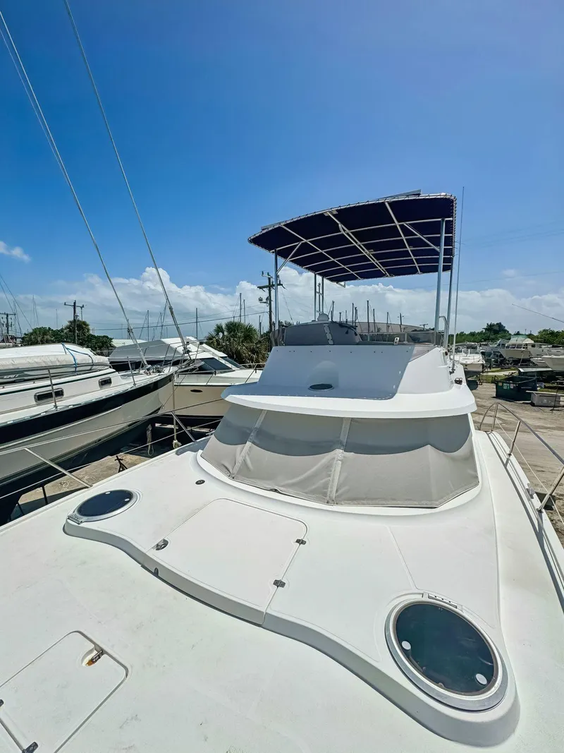Slide: The Image of 2005 Fountaine Pajot HIGHLAND yacht docked in a marina under a clear blue sky. - 10