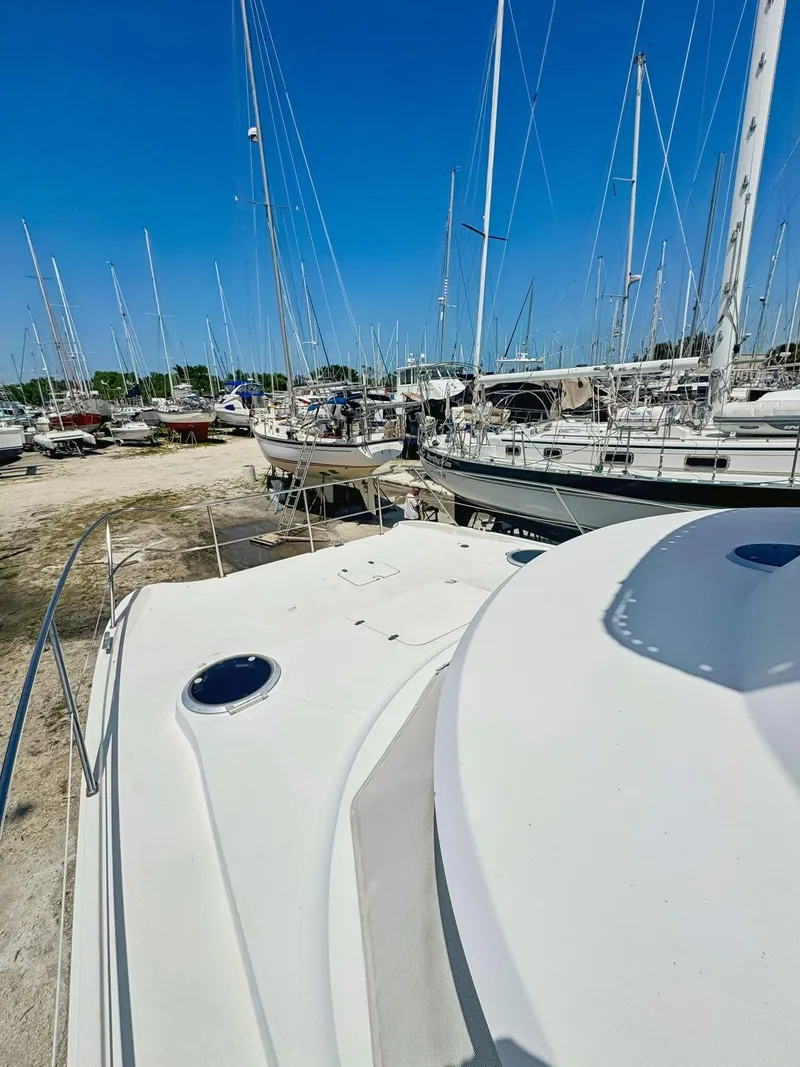 Slide: The Image of 2005 Fountaine Pajot HIGHLAND yacht with upper deck and canopy under clear blue sky. - 14
