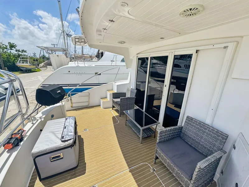 Slide: The Image of 2005 Fountaine Pajot HIGHLAND yacht with spacious deck and blue canopy. - 15
