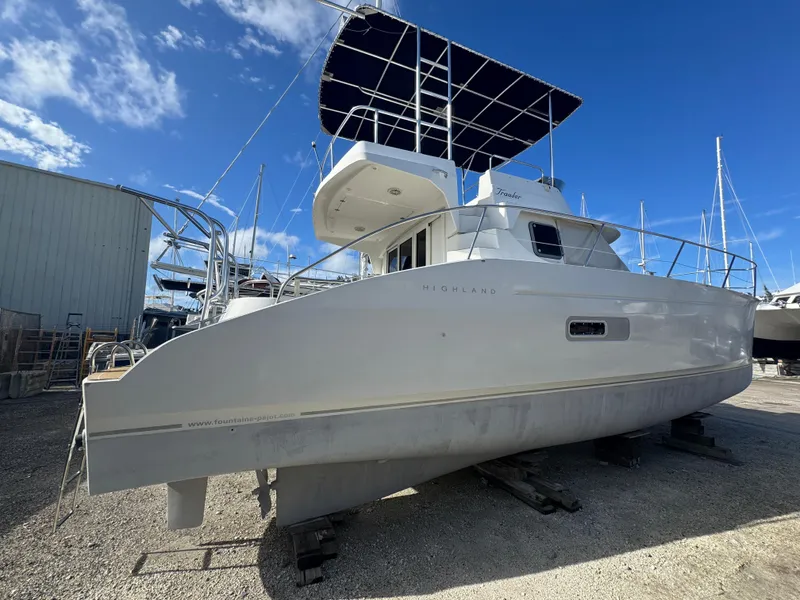 Slide: The Image of 2005 Fountaine Pajot HIGHLAND yacht on dry dock under clear blue sky. - 2