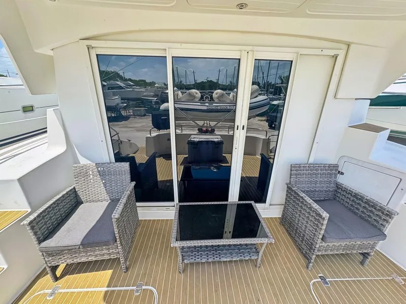 Slide: The Image of 2005 Fountaine Pajot HIGHLAND yacht interior with open fridge and wooden cabinetry. - 22