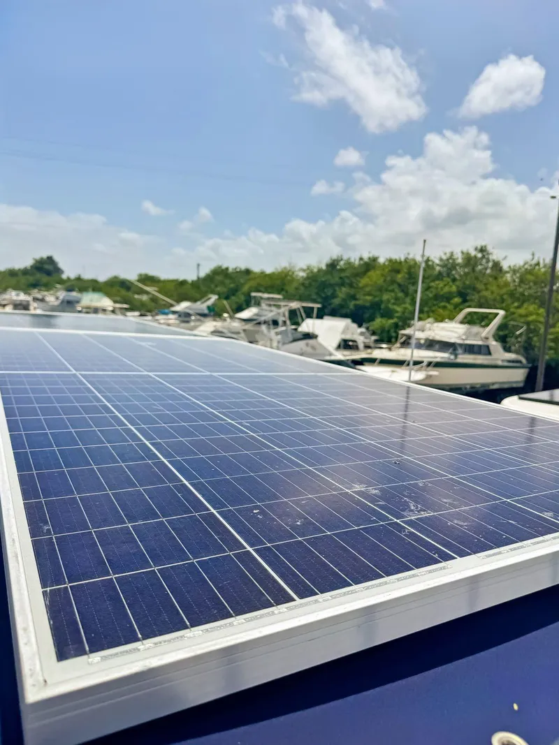 Slide: The Image of 2005 Fountaine Pajot HIGHLAND yacht helm with marina view, under blue canopy. - 42