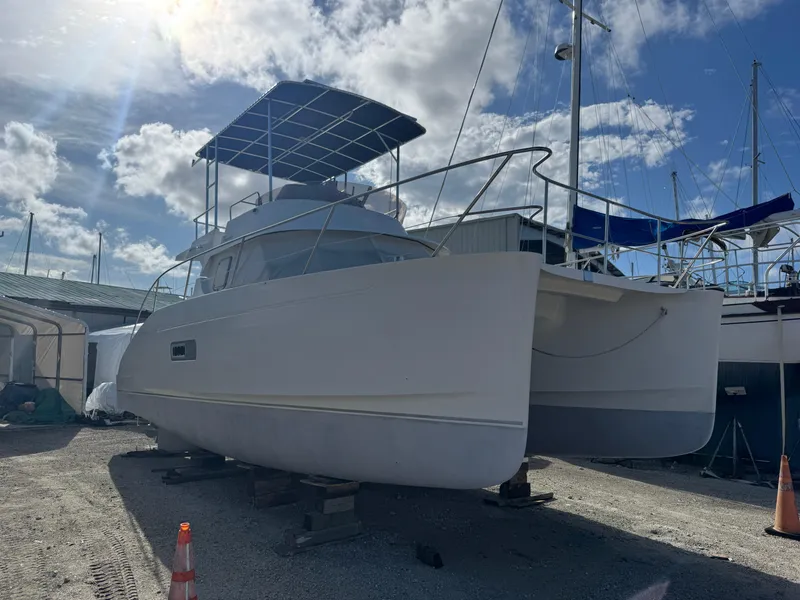 The Image of 2005 Fountaine Pajot HIGHLAND catamaran on dry dock under a sunny sky. - 0