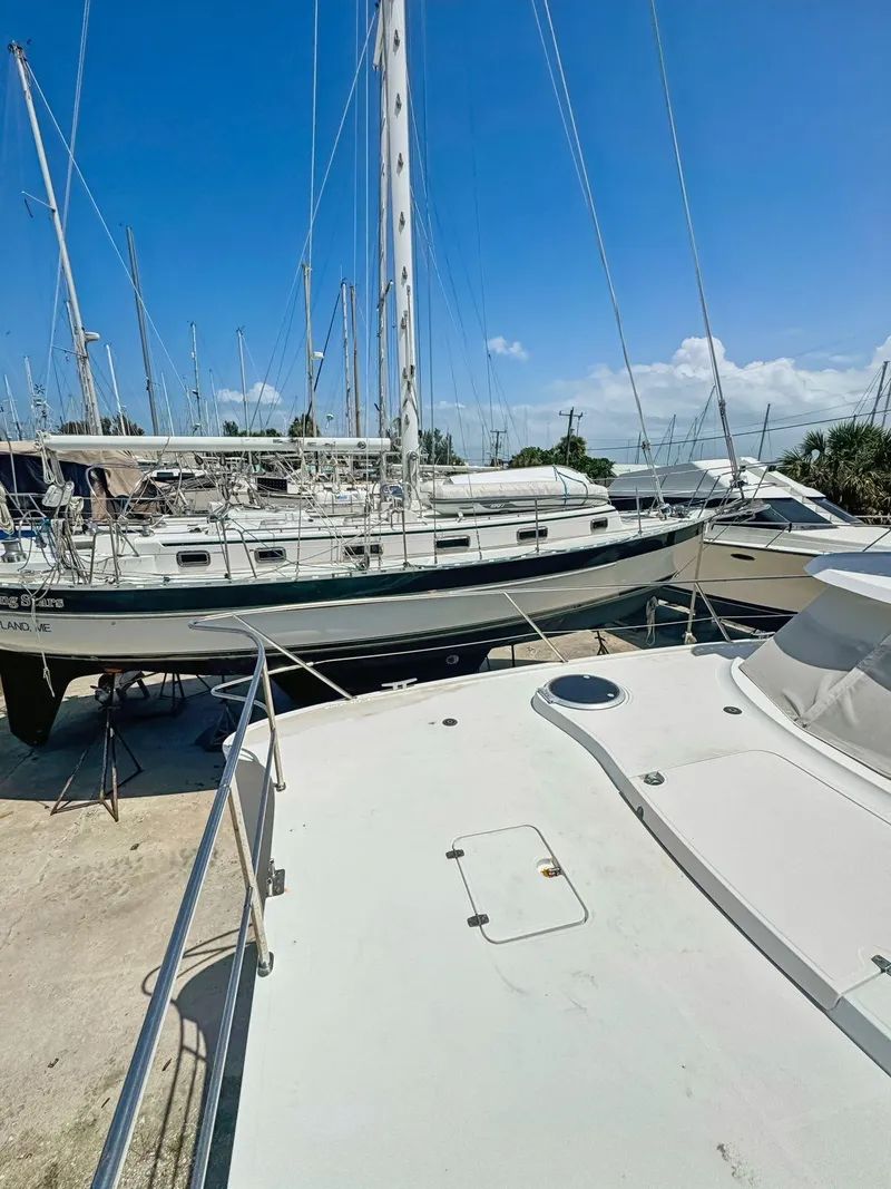Slide: The Image of 2005 Fountaine Pajot HIGHLAND yacht with blue canopy, docked under clear sky. - 11
