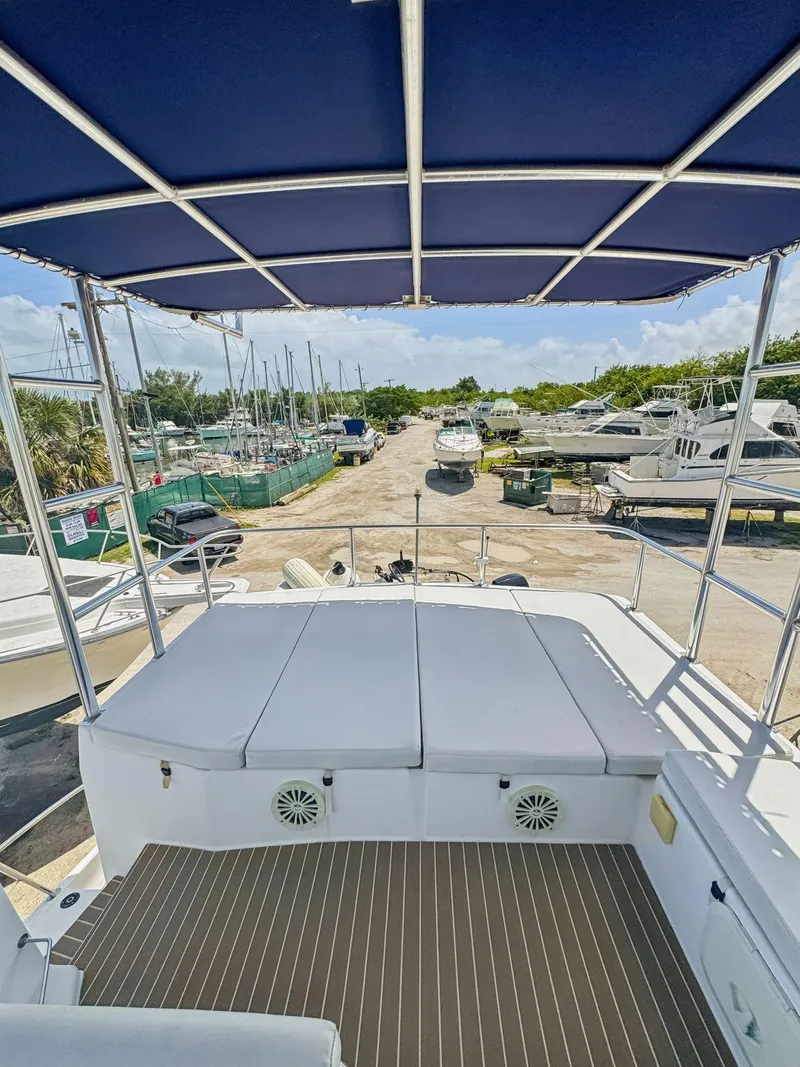 Slide: The Image of 2005 Fountaine Pajot HIGHLAND yacht with spacious deck and canopy, docked at marina. - 18