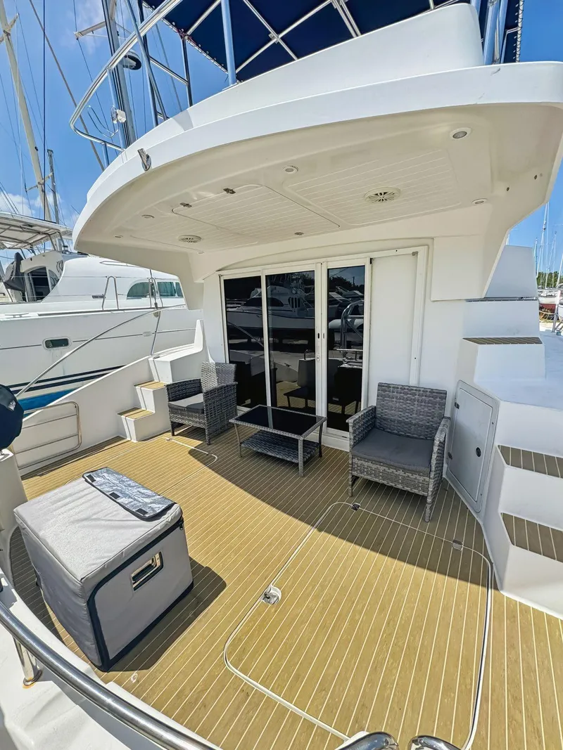 Slide: The Image of Outdoor seating area on 2005 Fountaine Pajot HIGHLAND yacht with wicker chairs and glass table. - 19