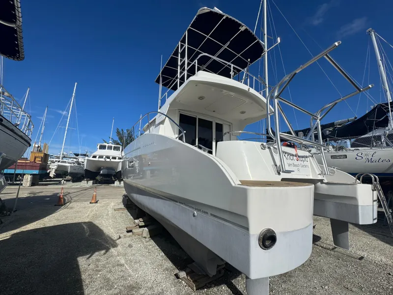 Slide: The Image of 2005 Fountaine Pajot HIGHLAND catamaran on dry dock under clear blue sky. - 5
