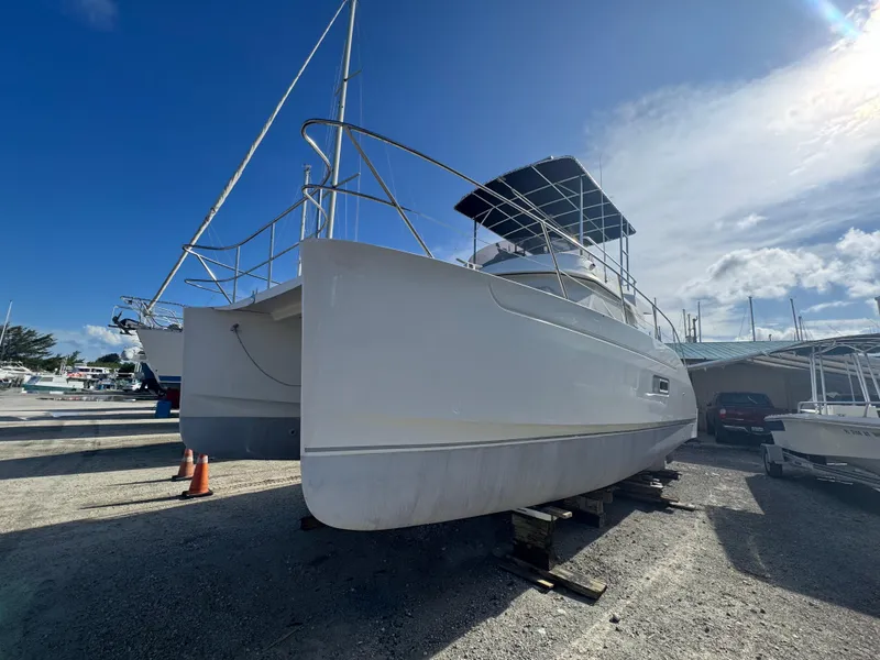 Slide: The Image of 2005 Fountaine Pajot HIGHLAND catamaran on dry dock under clear blue sky. - 6
