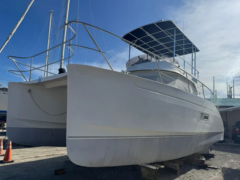 Slide: The Image of 2005 Fountaine Pajot HIGHLAND catamaran on dry dock under clear blue sky. - 7