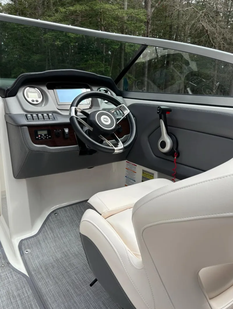Slide: The Image of 2017 Chaparral 210 Suncoast boat interior with steering wheel and dashboard. - 10