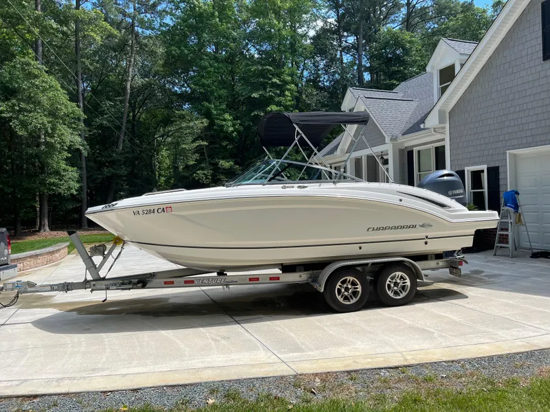 Slide: The Image of 2017 Chaparral 210 Suncoast boat on trailer, parked in driveway near house. - 3