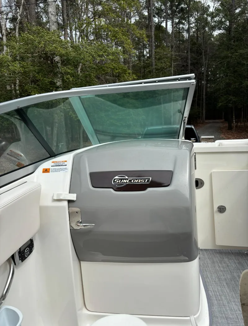 Slide: The Image of 2017 Chaparral 210 Suncoast boat interior with windshield and storage compartment. - 6