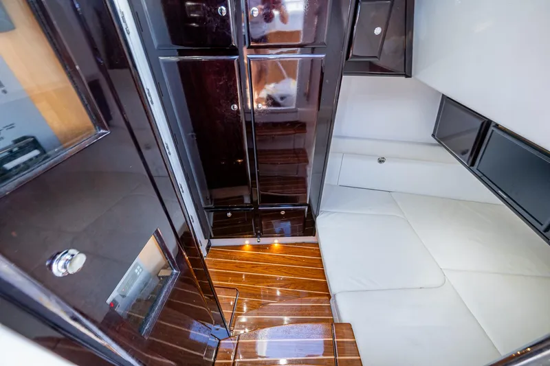 Slide: The Image of Luxurious interior of 2020 HCB 53 boat with sleek wood flooring and modern cabinetry. - 10