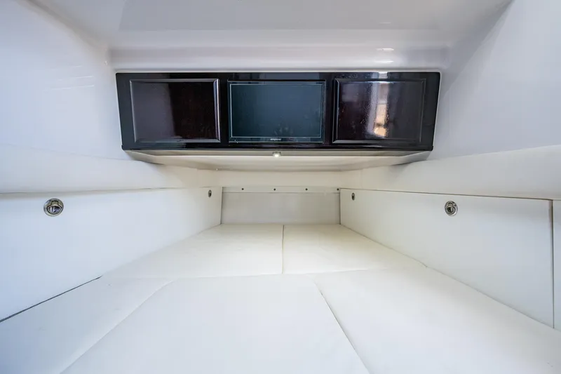 Slide: The Image of Interior cabin of 2020 HCB 53 boat with sleek white seating and modern entertainment system. - 12