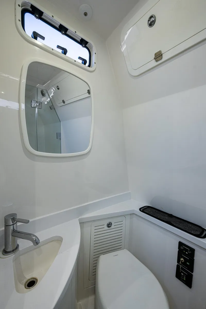 Slide: The Image of 2020 HCB 53 yacht bathroom with sink, mirror, and toilet. - 13