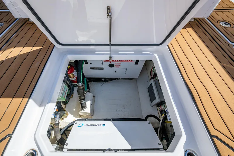 Slide: The Image of Open hatch of 2020 HCB 53 boat showing engine compartment and equipment. - 14