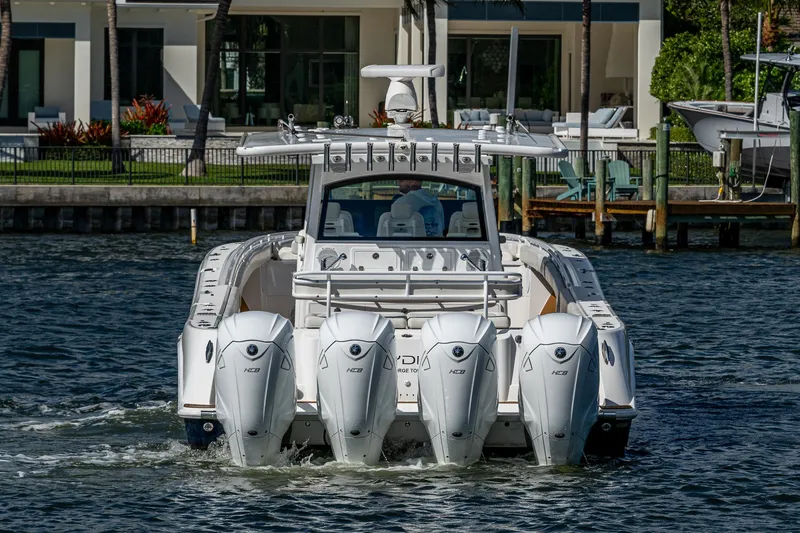 Slide: The Image of 2020 HCB 53 boat with four powerful outboard engines on the water. - 2
