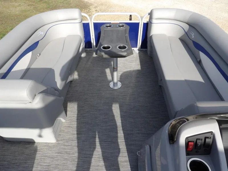Slide: The Image of 2023 Bennington 20 SVSR pontoon boat interior with gray seating and central table. - 13