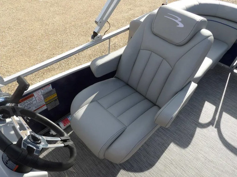 Slide: The Image of 2023 Bennington 20 SVSR boat captain's chair and steering wheel, featuring sleek design and comfort. - 20