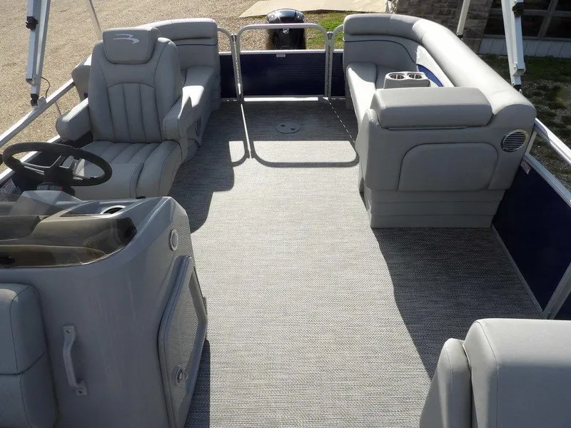 Slide: The Image of 2023 Bennington 20 SVSR pontoon boat interior with gray seating and steering console. - 23